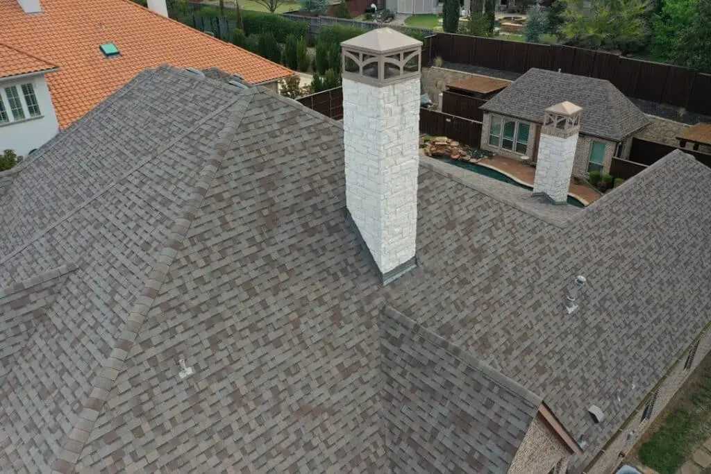 Final result of roof repair and chimney stone veneers