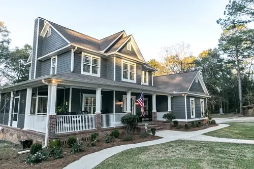 Luxury home with dark vinyl siding