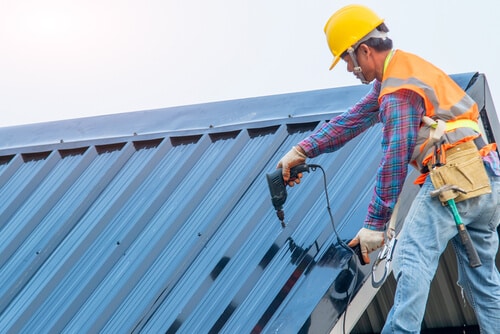 A Roofer Installs Metal Residential Roof