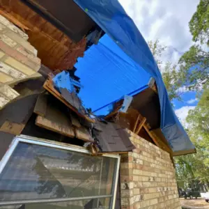 this roof in Tyler, tx was destroyed by an old tree