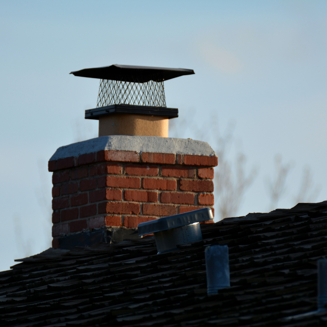 image of a chimney on a roof and showing off the chimney crown