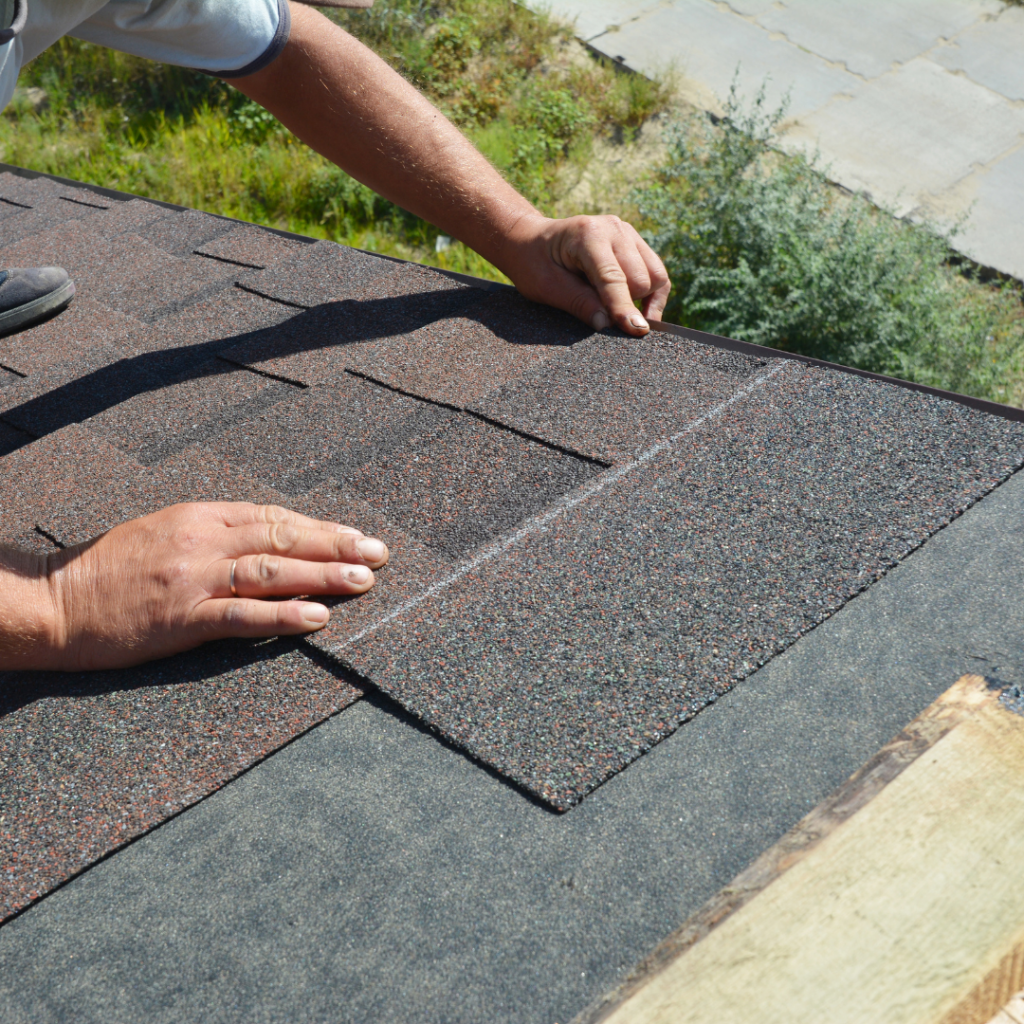 crew installing asphalt on a roof