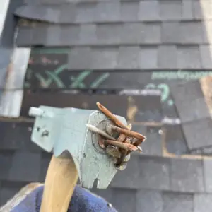 rusted nails on damaged shingles