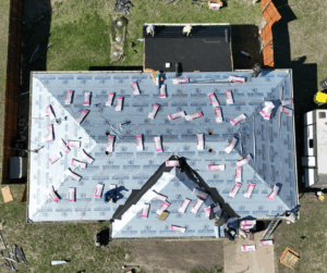 Roofing crew installing new asphalt shingles on home in Waxahachie during spring