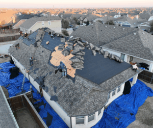 Home with shingle roof under installation during hot Dallas summer