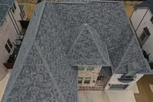 Aerial view of complex shingle roof layout showing low-slope area needing repair in Frisco TX