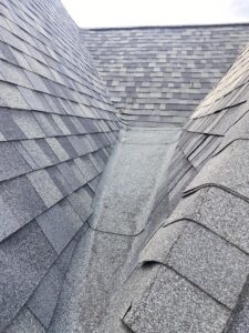 Valley area on Frisco roof showing improper shingle installation on a low-slope section